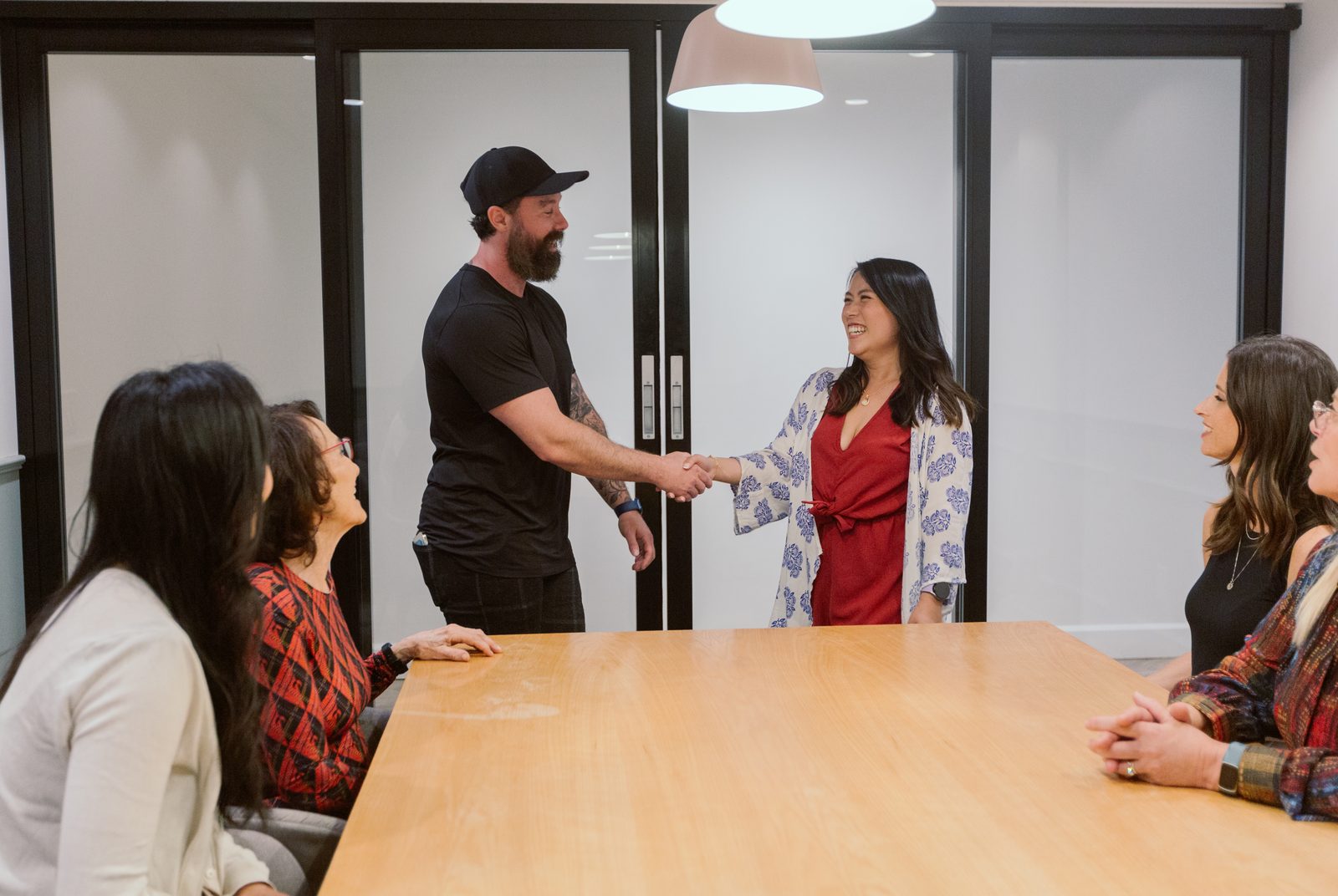 Warm handshake welcome during a TurnFit consultation for midlife strength and longevity coaching