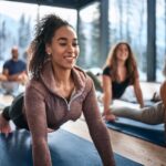 Woman stretching during indoor group yoga class in Vancouver
