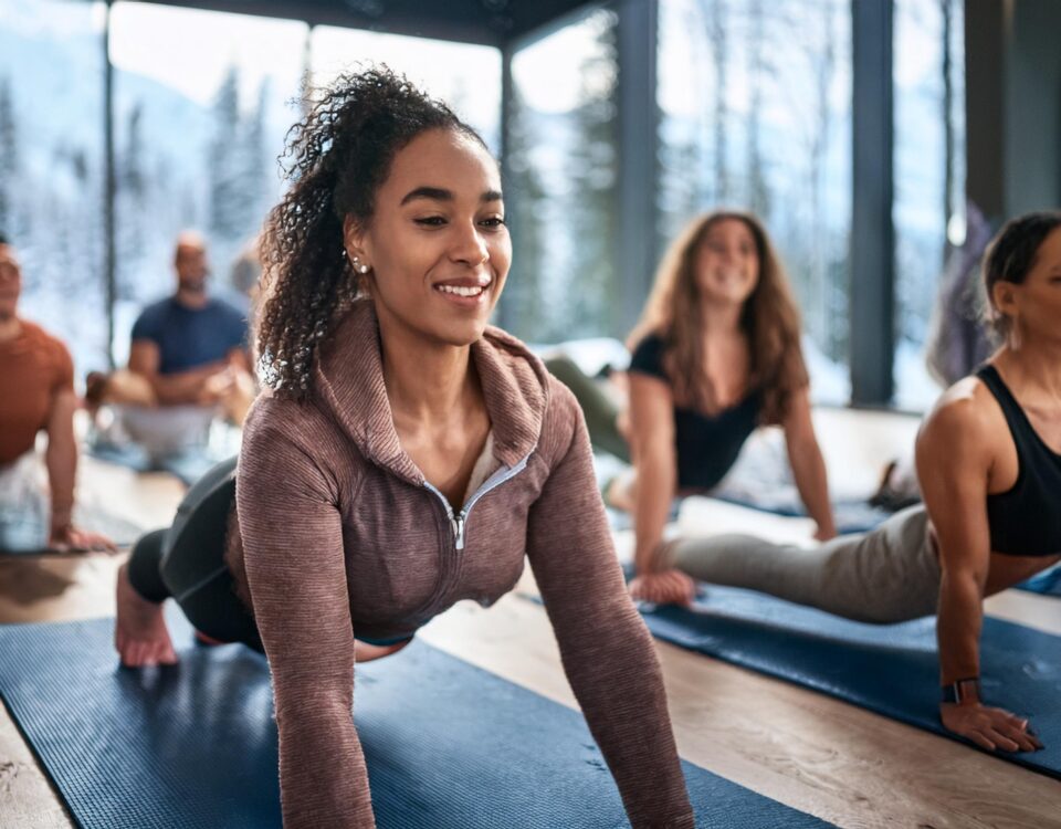 Woman stretching during indoor group yoga class in Vancouver