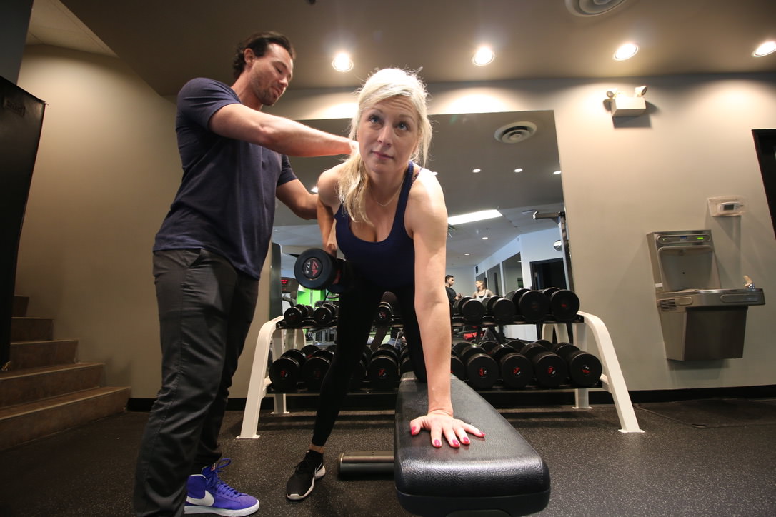 Woman performing a one-arm dumbbell row