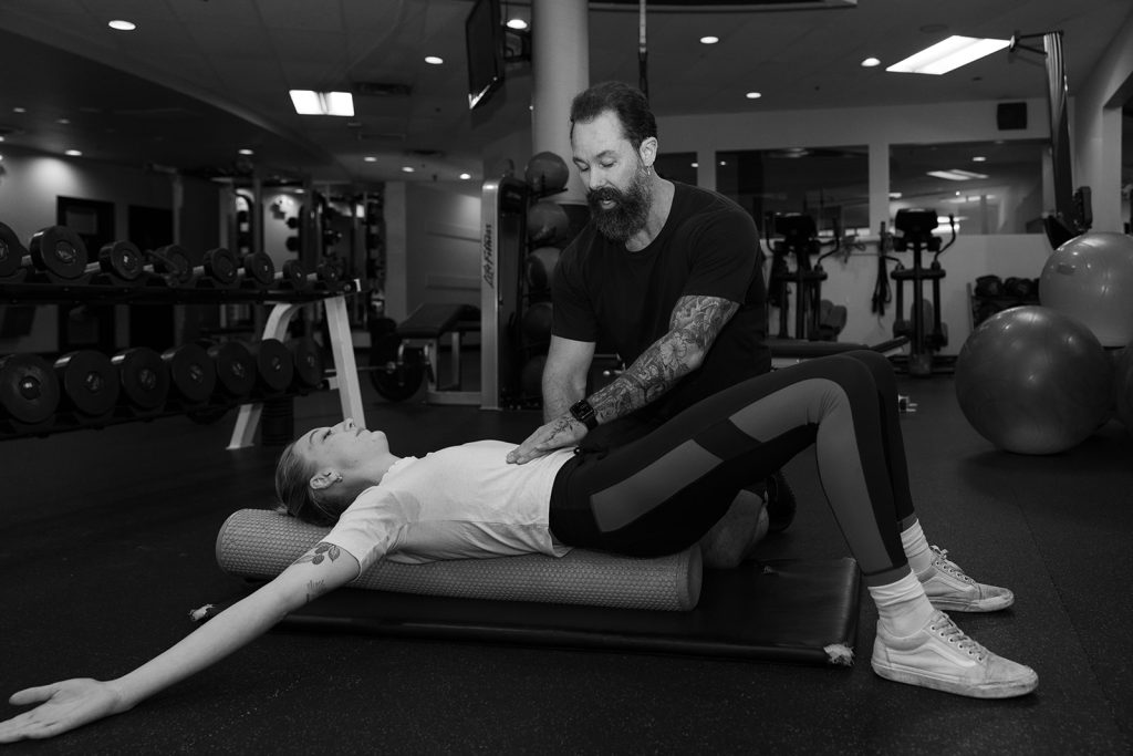 David Turnbull coaching posture and core work on a foam roller at TurnFit Vancouver