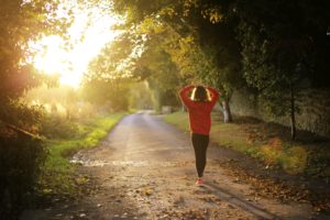 woman walking outdoors with sunlight