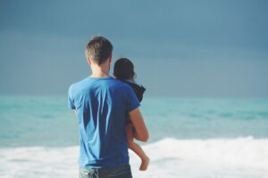 Man holding child at the beach