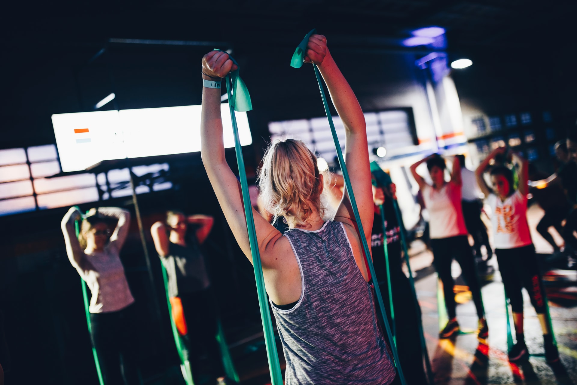 Group fitness class using resistance bands for functional training exercises