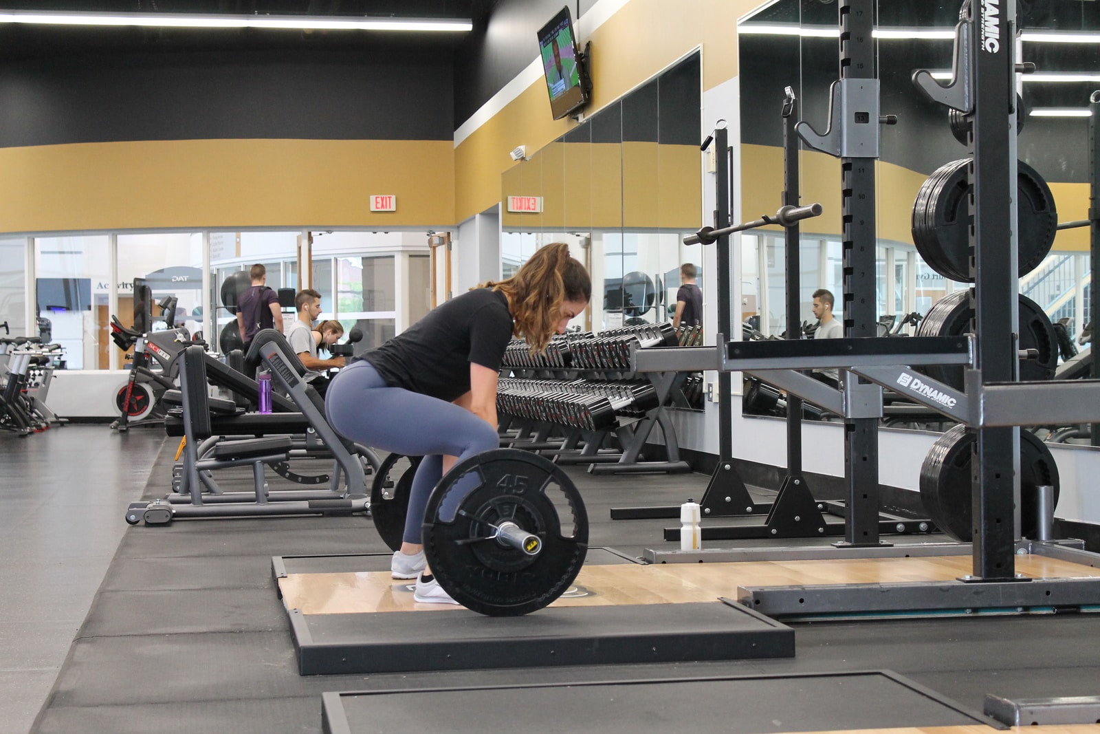 TurnFit woman lifting barbell