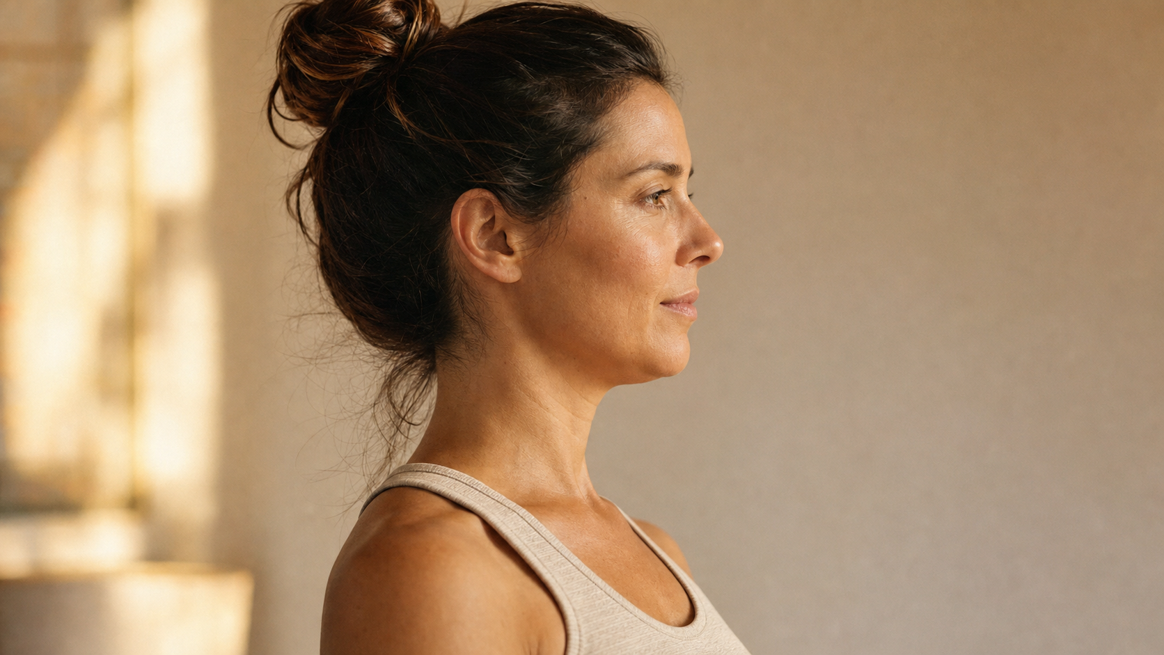 Woman demonstrating proper chin tuck posture cue for cervical spine alignment